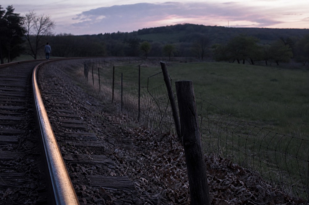 Rail tracks running past a fence line near Sonoma County farmland, no text, no logos, no people
