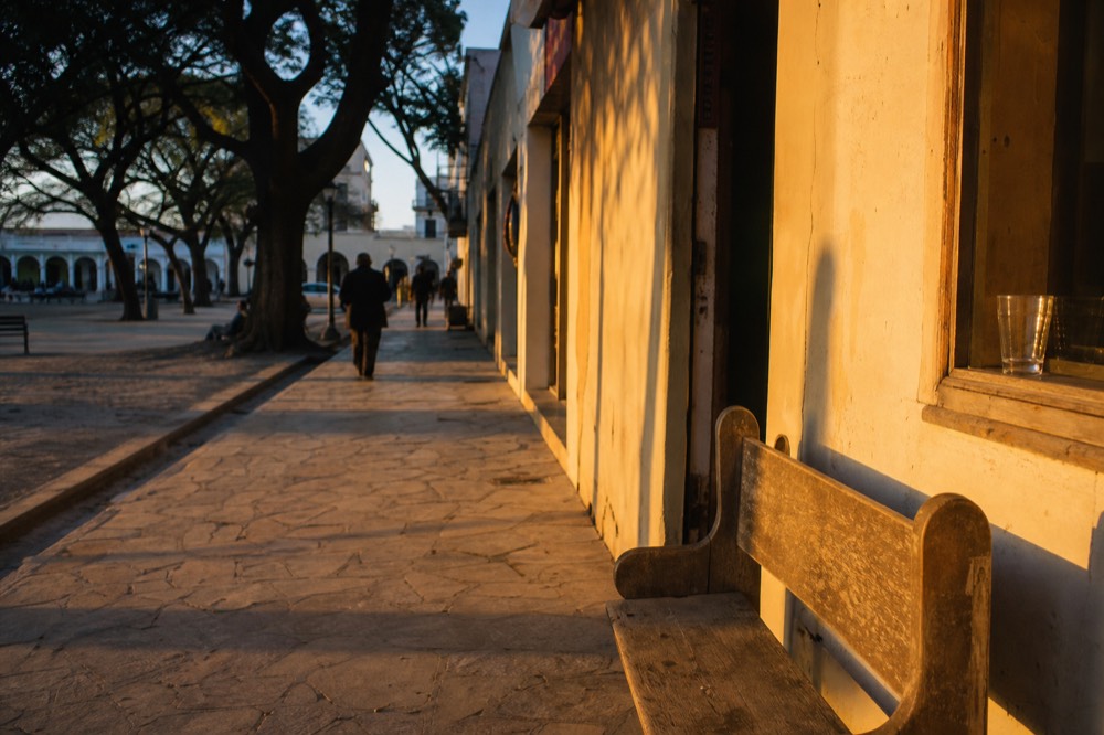 Sunlit walkway beside Sonoma Plaza leading to a tasting room door, no text, no logos, no people