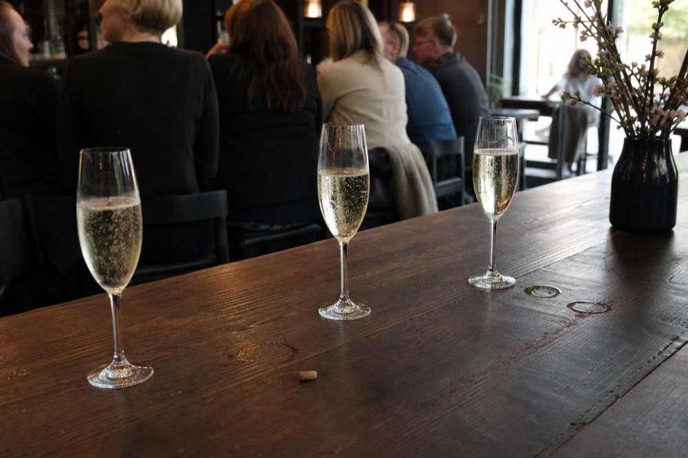 Glasses of sparkling wine on a bar counter near Sonoma Plaza, no text, no logos, no people